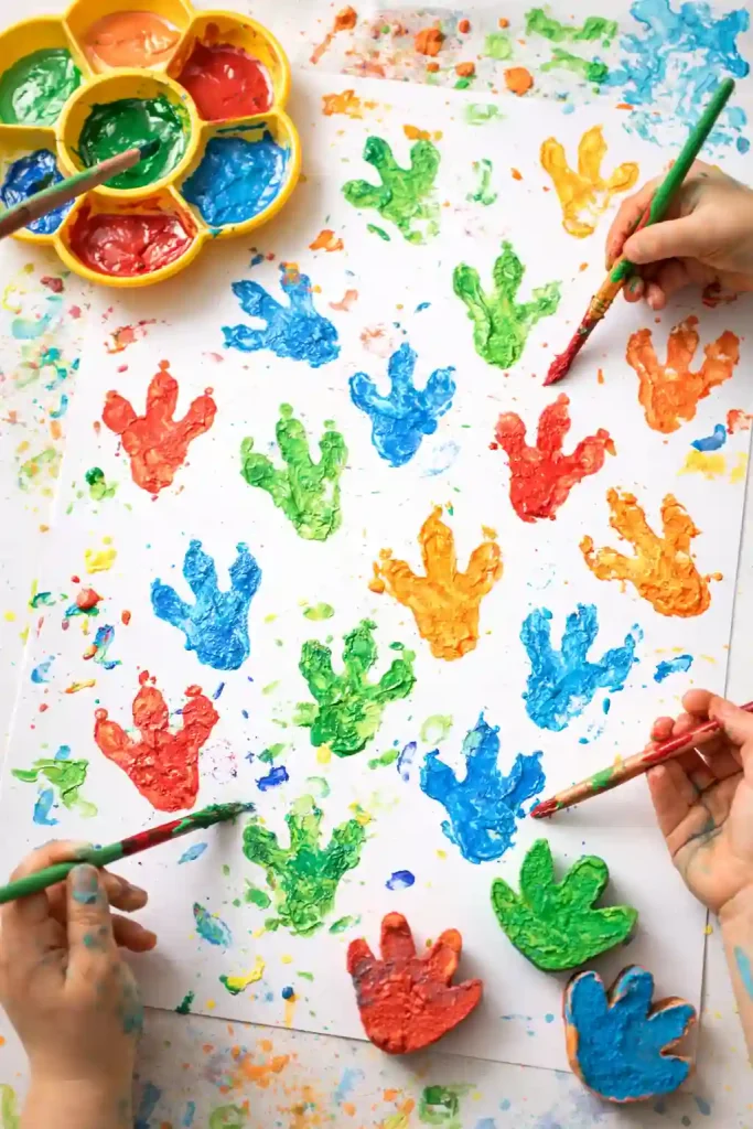 Painted dinosaur footprints stamped across paper